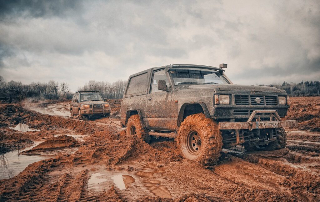 truck with 4x4 tyres driving through mud